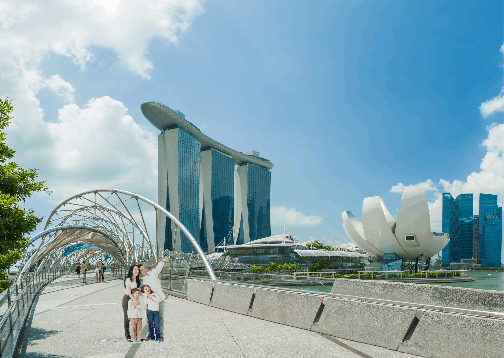 Family enjoying a vacation in Singapore with a scenic view of Marina Bay and city skyline in the background.