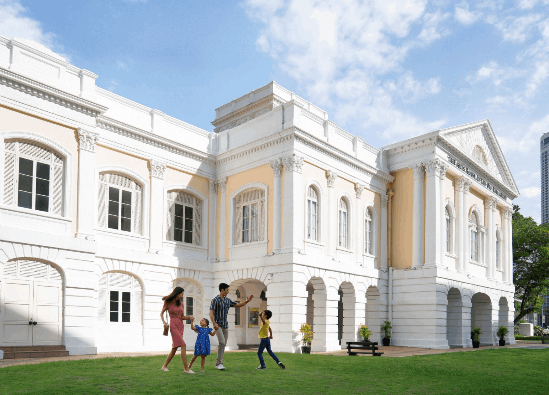 Family exploring the historical Civic District in Singapore, featuring colonial architecture and the National Gallery.