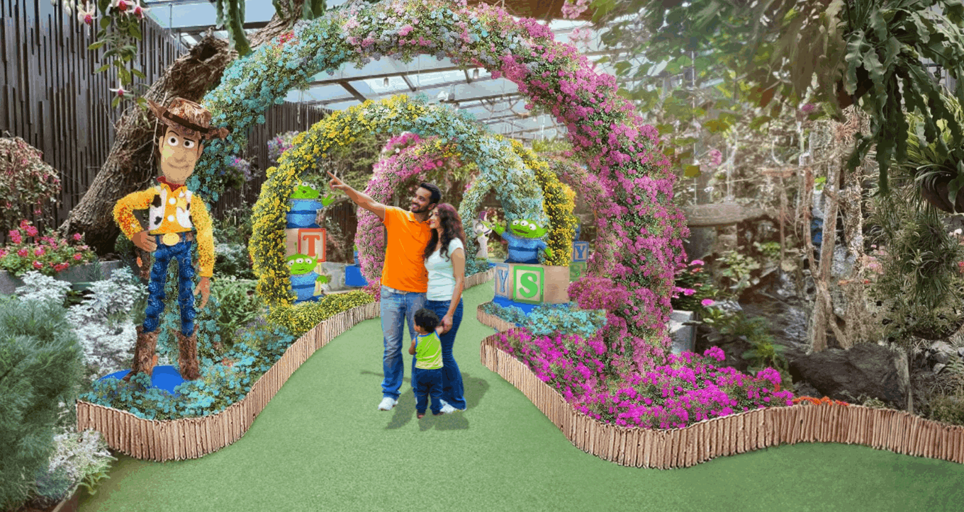 Indian family exploring the colorful Disney-themed Floral Fantasy garden in Singapore