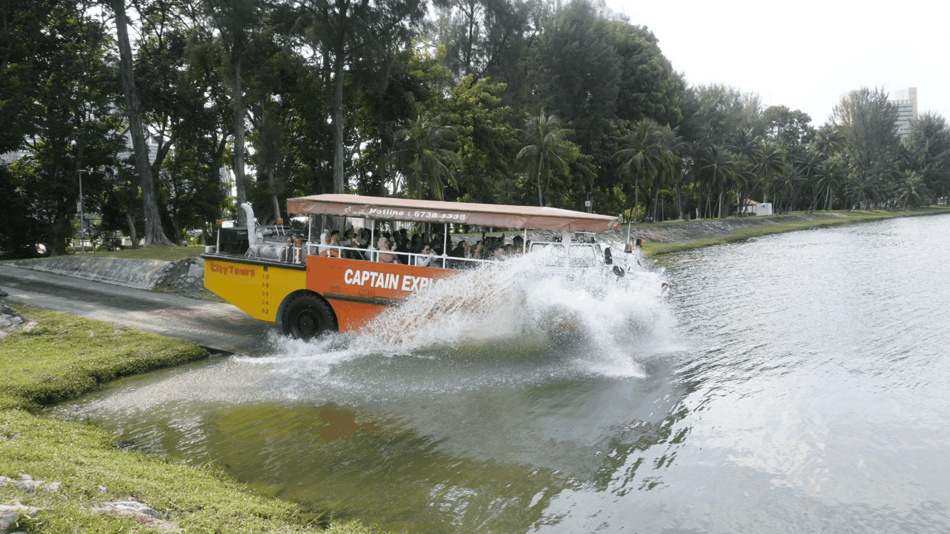Captain Explorer DUKW Tour splashing into the water in Singapore, a fun land and sea sightseeing experience for first-time visitors.