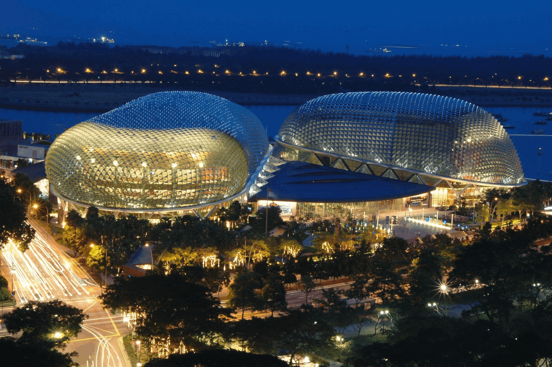 Esplanade Theatres on the Bay illuminated at night, a scenic landmark to view while exploring Marina Bay on a budget in Singapore.