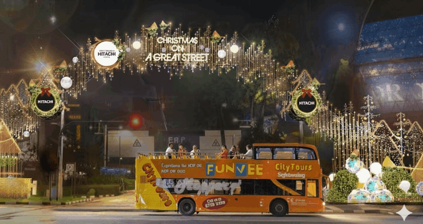 A FunVee City Tours open-top bus driving under the official "Christmas on a Great Street" light-up arch on Orchard Road at night.