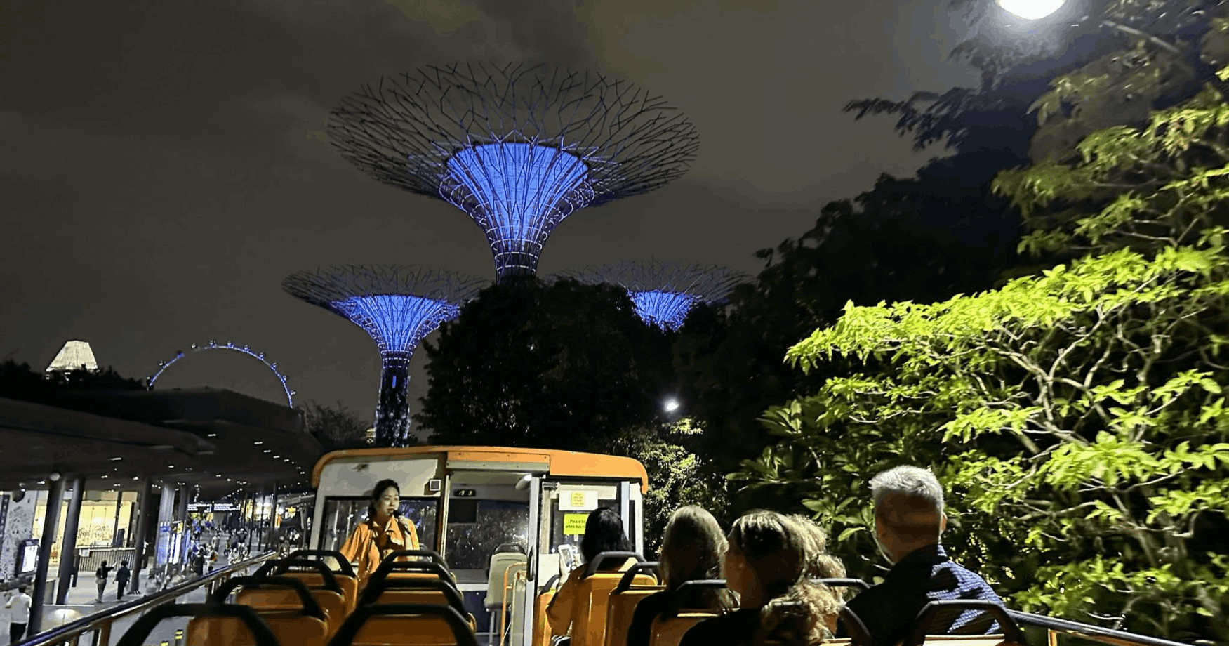 Families and groups enjoying the FunVee Night Tour on the double-decker open-top bus, capturing memories of Singapore's Chinese New Year lights and festive atmosphere.