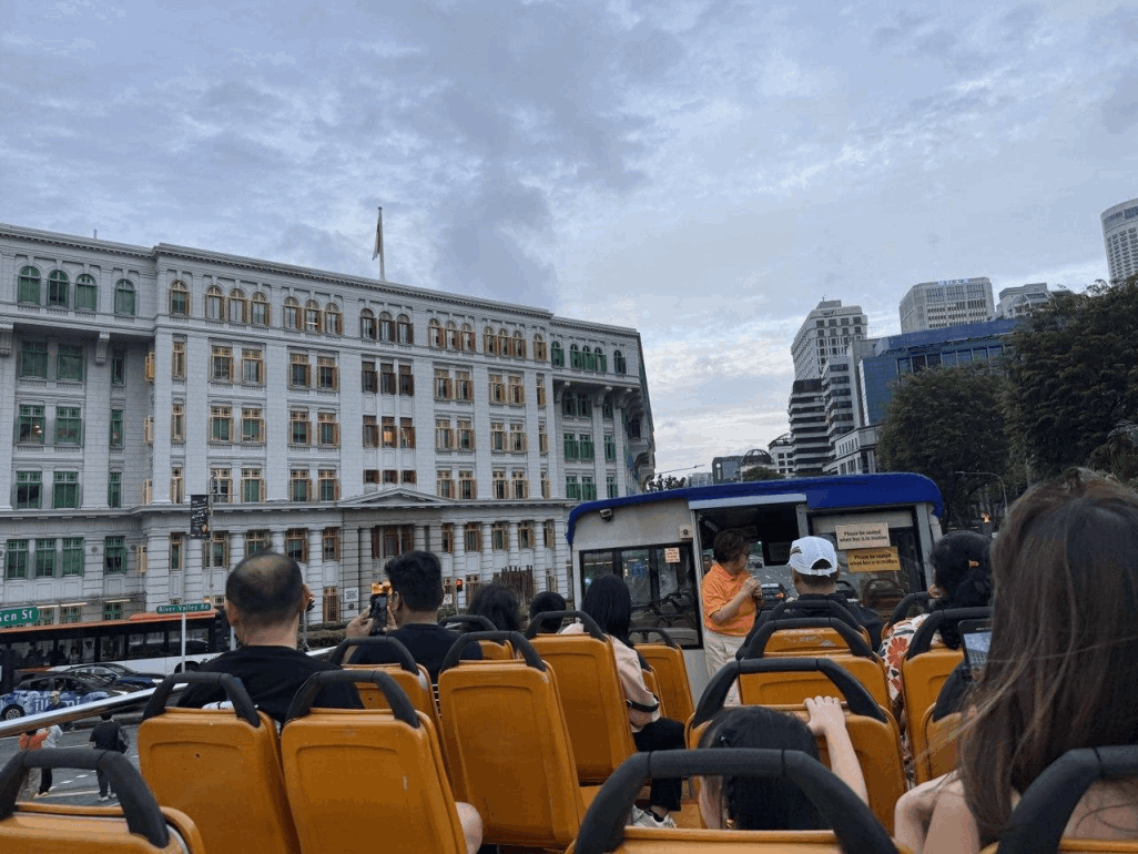 Family riding the FunVee Open-Top Bus, enjoying panoramic views of Singapore's attractions during Hari Raya Haji.