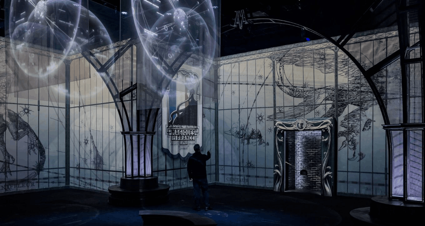 A magical exhibit from Harry Potter: Visions of Magic with glowing projections and wizard-themed rooms.