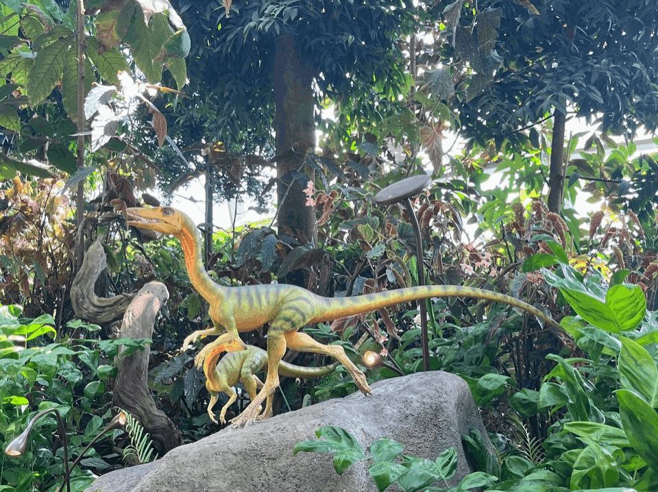 Dinosaur sculpture surrounded by lush greenery at the Jurassic-themed zone at Gardens by the Bay, Singapore.