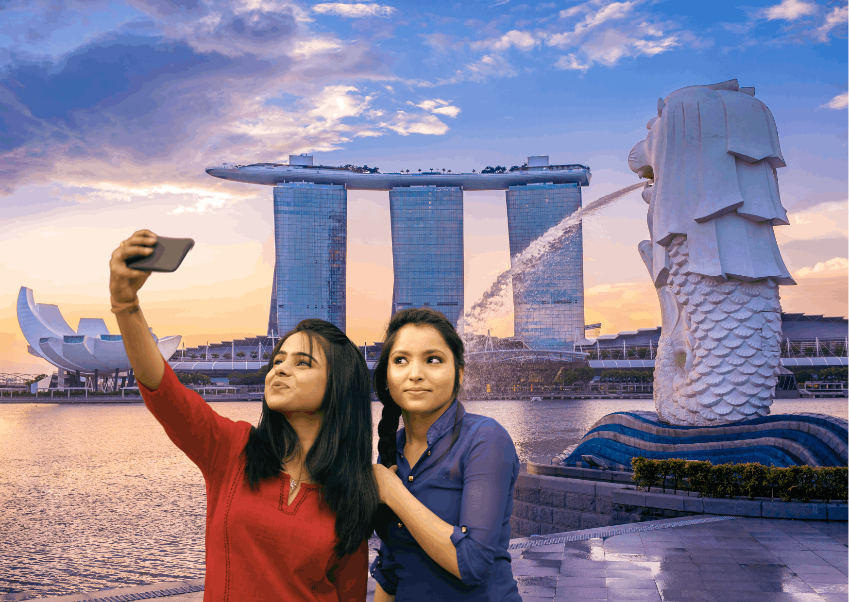 A scenic view of Merlion Park with the Merlion statue and Marina Bay Sands in the background.