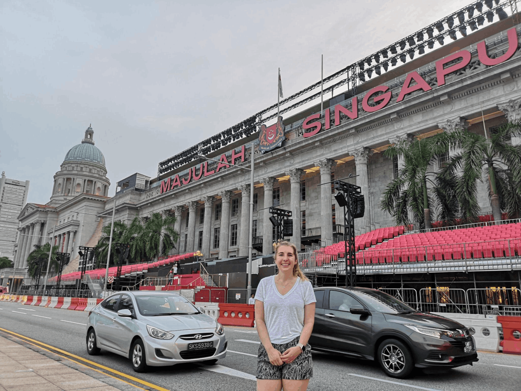Tourist in front of the Padang grandstand setup for Singapore’s National Day 2025, with “Majulah Singapore” signage in the background