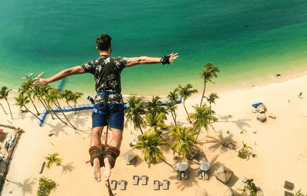 Bungee jump tower at Sentosa Island beach with sunset in the background