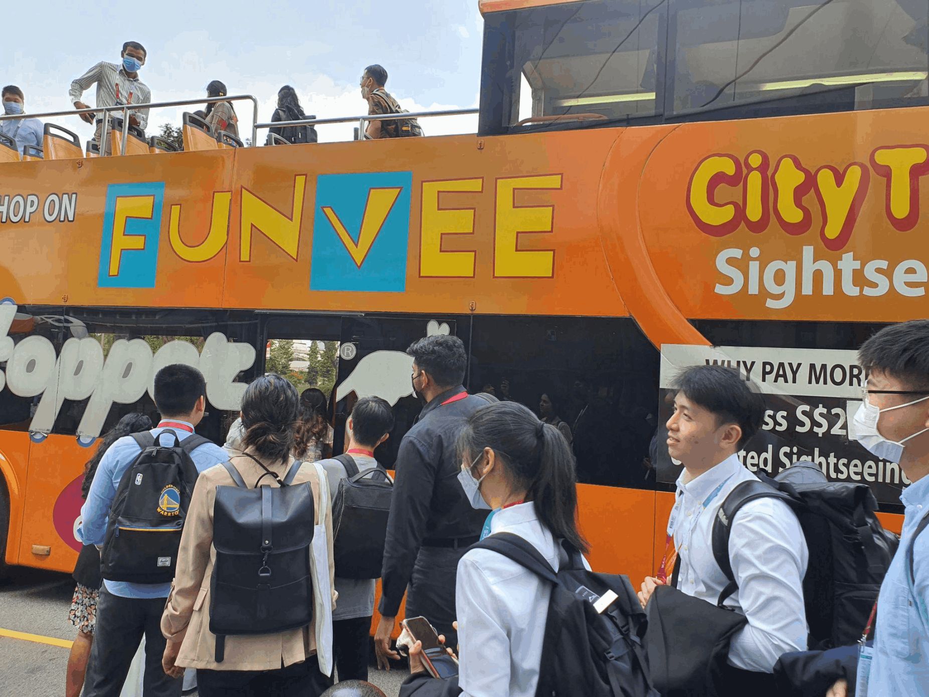 Visitors boarding the FunVee open-top bus in Singapore for a city sightseeing and SG Culture Pass heritage tour experience.