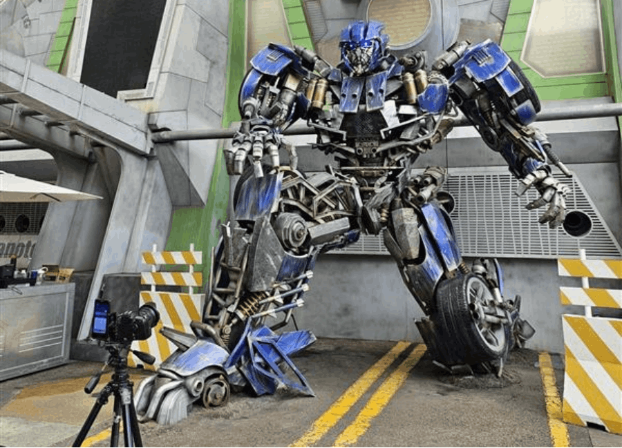 Thrilling Transformers ride at Universal Studios Singapore with excited Indian tourists enjoying the 3D experience.